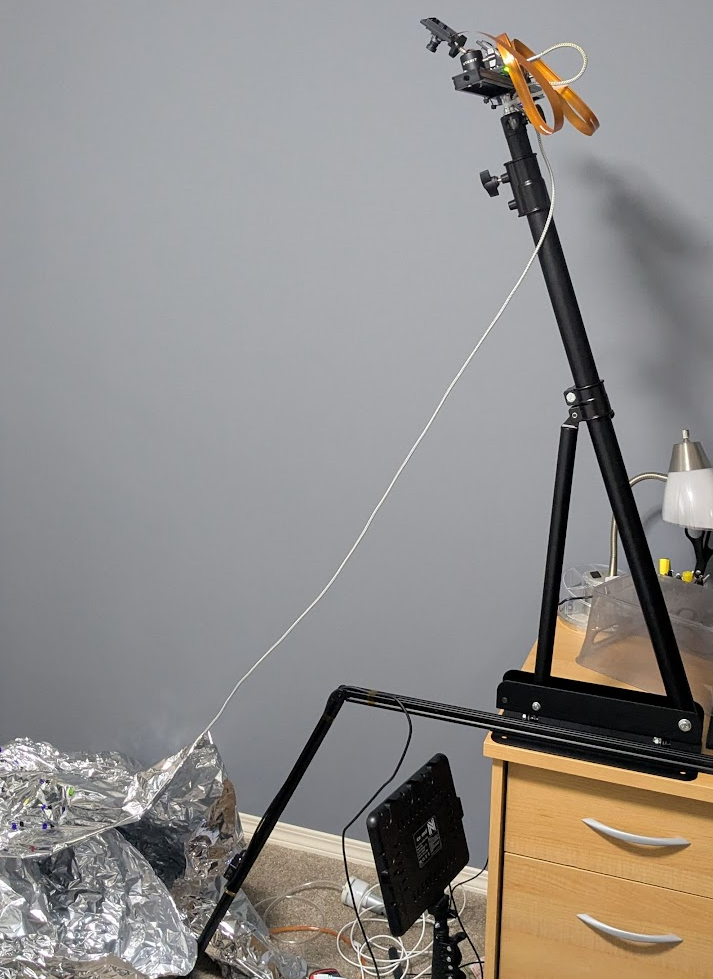 Balloon inflation test rig showing the inclinometer swing arm and stereo camera setup