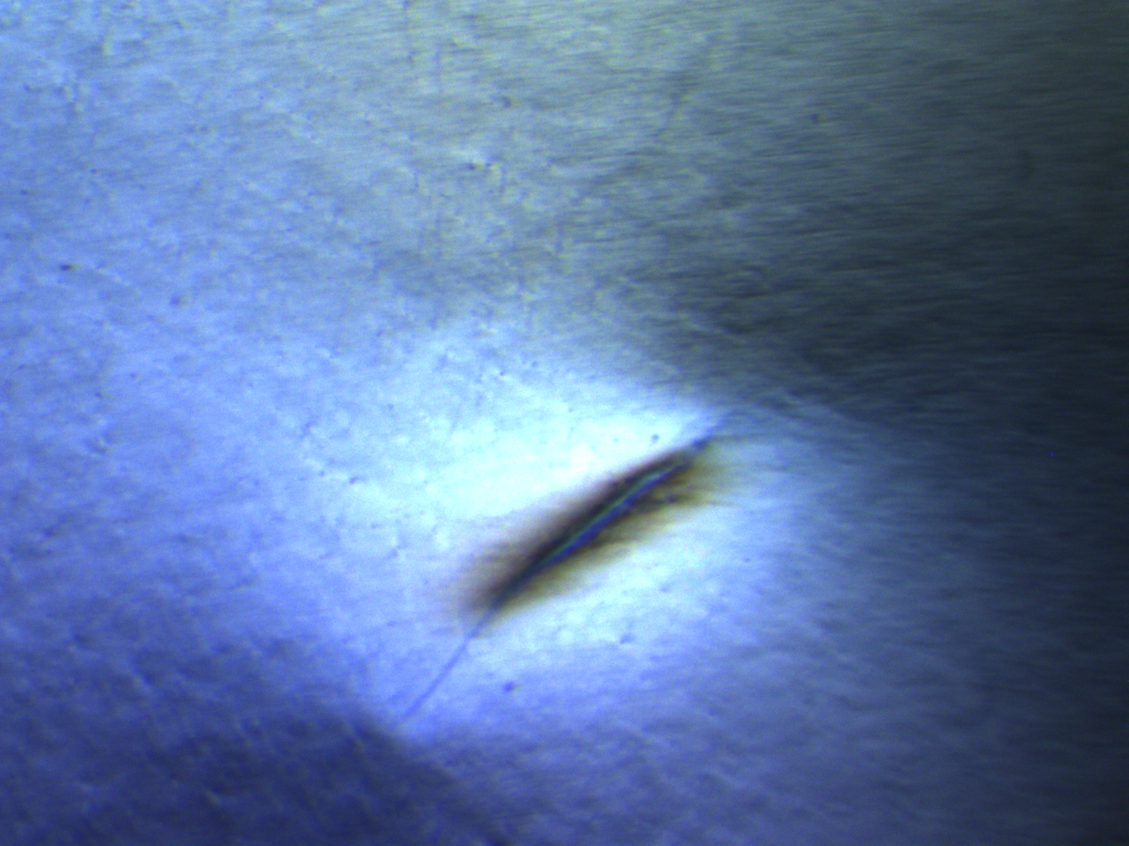 Balloon flaw under cross-polarized light at 90 degrees